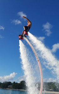 A man is flying through the air on water skis.