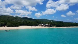 A beach with people swimming in the water