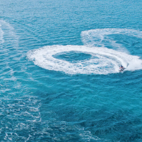 A person on water skis in the middle of the ocean.