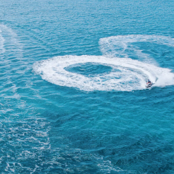 A person on water skis in the middle of the ocean.