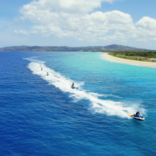 A group of people riding water skis on top of a body of water.