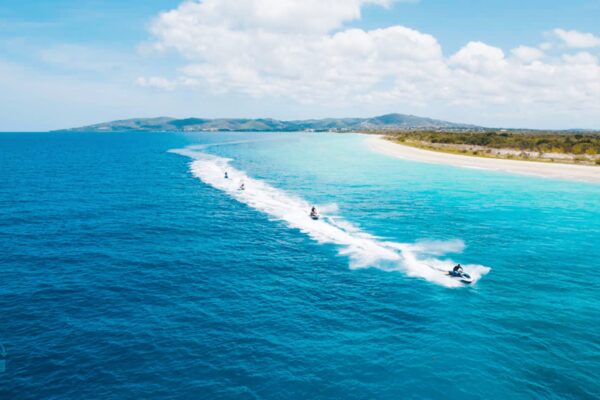A group of people riding water skis on top of a body of water.